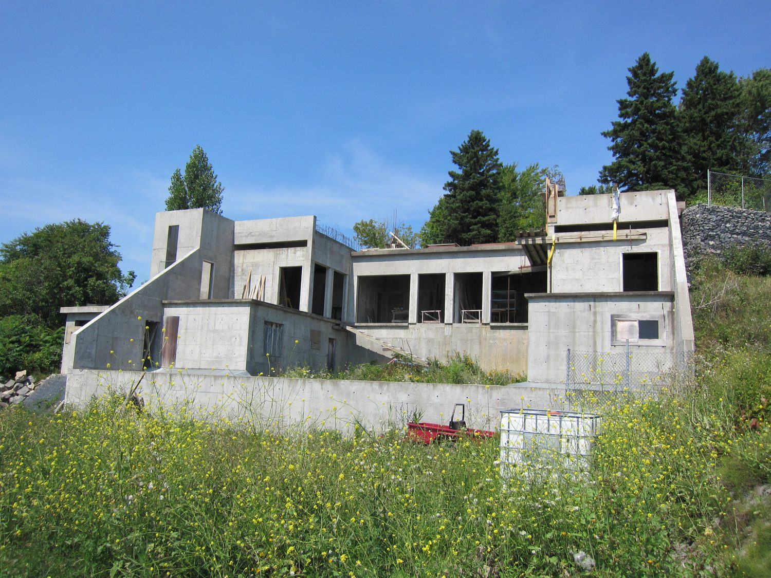 Winterholm under construction: the reinforced concrete shell rising in stages on the hillside.